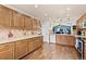 Bright kitchen with granite countertops, tile backsplash and stainless steel appliances leading to an open floorplan at 1128 S Duquesne Cir, Aurora, CO 80018