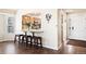 Open-concept kitchen with breakfast bar, hardwood floors, and modern finishes at 1128 S Duquesne Cir, Aurora, CO 80018
