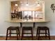 Open kitchen with bar seating, wood cabinets, and an adjacent dining area at 1128 S Duquesne Cir, Aurora, CO 80018