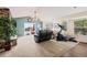 Cozy living room featuring a vaulted ceiling, sliding doors, and stone fireplace at 1128 S Duquesne Cir, Aurora, CO 80018