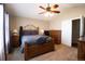 Inviting main bedroom featuring a ceiling fan, soft carpet and warm decor at 1128 S Duquesne Cir, Aurora, CO 80018