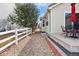 Side yard of house features rock ground covering and a small patio with furniture at 1128 S Duquesne Cir, Aurora, CO 80018