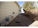 Gravel side yard with utilities and natural landscaping, offering functionality and low maintenance at 1128 S Duquesne Cir, Aurora, CO 80018