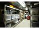 Basement storage room featuring metal shelving filled with storage containers at 1128 S Duquesne Cir, Aurora, CO 80018