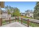 Upper deck showing railing with view of the backyard and other homes in the community at 6382 Freeport Dr, Highlands Ranch, CO 80130
