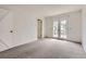 Bedroom featuring neutral carpet and French doors leading to a balcony at 6382 Freeport Dr, Highlands Ranch, CO 80130