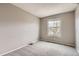 A bedroom showcasing neutral walls and carpet and a window allowing for ample natural light at 6382 Freeport Dr, Highlands Ranch, CO 80130