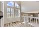 Bright and open dining area with a view of the Gathering room and a large arched window at 6382 Freeport Dr, Highlands Ranch, CO 80130