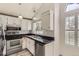 Kitchen features stainless steel appliances, black countertops, and white cabinets at 6382 Freeport Dr, Highlands Ranch, CO 80130