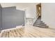 Living room featuring wood floors and staircase access at 6382 Freeport Dr, Highlands Ranch, CO 80130