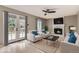 Cozy living room featuring a fireplace, white furniture with blue accents, and french doors leading to the patio at 6382 Freeport Dr, Highlands Ranch, CO 80130