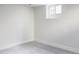 Unfinished basement room with gray carpet and a window at 1315 Holly St, Denver, CO 80220