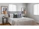 Cozy bedroom with gray headboard and neutral decor at 1315 Holly St, Denver, CO 80220