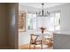 Bright dining area with a round table and chairs, adjacent to the kitchen at 1315 Holly St, Denver, CO 80220