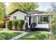 Charming updated bungalow with a sunroom and well-manicured lawn at 1315 Holly St, Denver, CO 80220