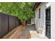 Side yard with walkway, fence, and mature trees at 1315 Holly St, Denver, CO 80220