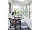 Sunroom with black wicker furniture and striped rug at 1315 Holly St, Denver, CO 80220