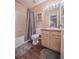 Clean bathroom with a shower/tub combo and wood cabinets at 13616 Garfield St # B, Thornton, CO 80602