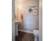 Small bathroom with pedestal sink and dark wood flooring at 13616 Garfield St # B, Thornton, CO 80602