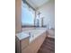 Relaxing bathroom with a soaking tub and tile surround at 13616 Garfield St # B, Thornton, CO 80602