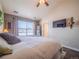 Main bedroom with king-size bed and window views at 13616 Garfield St # B, Thornton, CO 80602