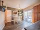 Dining area with white table and chairs near sliding glass doors at 13616 Garfield St # B, Thornton, CO 80602