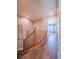 Upstairs hallway with wooden flooring and doors to bedrooms at 13616 Garfield St # B, Thornton, CO 80602