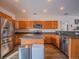 Kitchen with island, stainless steel appliances, and wood cabinets at 13616 Garfield St # B, Thornton, CO 80602