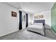 Bright bedroom with a large window providing natural light, complemented by neutral gray carpet at 1287 S Wheeling Way, Aurora, CO 80012