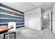 Charming bedroom featuring floating shelves, sliding closet, and gray carpet at 1287 S Wheeling Way, Aurora, CO 80012