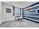 Well-lit bedroom with accent wall, built-in shelves, and a desk at 1287 S Wheeling Way, Aurora, CO 80012