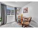 Cozy dining area features a window, gray curtains, a small table, and comfortable chairs at 1287 S Wheeling Way, Aurora, CO 80012