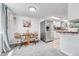 Cozy dining area adjacent to the kitchen, featuring a stainless steel refrigerator and warm lighting, creating an inviting atmosphere at 1287 S Wheeling Way, Aurora, CO 80012