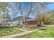 Charming townhome with blue siding, brick accents, and mature trees, nestled in a well-maintained lawn and landscaped community at 1287 S Wheeling Way, Aurora, CO 80012