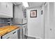 This laundry area features stacked washer/dryer and storage cabinets at 1287 S Wheeling Way, Aurora, CO 80012