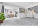Bright living area with plush carpeting, seamlessly connecting to a dining area and kitchen, creating an open and inviting space at 1287 S Wheeling Way, Aurora, CO 80012