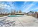 Community pool surrounded by a fence and patio, with nearby housing at 1287 S Wheeling Way, Aurora, CO 80012