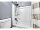 Bathroom shower with white shower walls, black fixtures, and neutral curtain at 1287 S Wheeling Way, Aurora, CO 80012