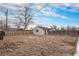 The large backyard features a shed and is enclosed with wooden fences at 206 Cedar St, Hudson, CO 80642