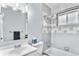 Bright bathroom featuring tiled walls, a shower-tub combo, and a modern sink at 206 Cedar St, Hudson, CO 80642