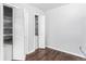 Bright bedroom featuring closet with shelves and hardwood flooring at 206 Cedar St, Hudson, CO 80642