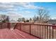 Red painted wooden deck overlooking the backyard, perfect for outdoor living at 206 Cedar St, Hudson, CO 80642