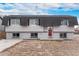 Charming two-story home featuring a red door and inviting curb appeal on a partially xeriscaped front yard at 206 Cedar St, Hudson, CO 80642