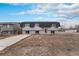 Exterior view of home and front yard showcasing curb appeal and driveway at 206 Cedar St, Hudson, CO 80642