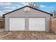 Garage with a basketball hoop above two white garage doors at 206 Cedar St, Hudson, CO 80642