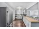 Updated kitchen features butcher block counters, stainless steel appliances, and a breakfast bar open to the living area at 206 Cedar St, Hudson, CO 80642