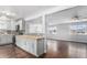 Modern kitchen with updated cabinets, backsplash, stainless steel appliances and butcher block countertops that open to living room at 206 Cedar St, Hudson, CO 80642