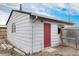 Exterior view of shed in backyard with red door and off-white siding at 206 Cedar St, Hudson, CO 80642