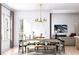 Bright dining area with a stylish chandelier, table, and chairs, next to the living room at 2021 Grayside Cir, Castle Rock, CO 80109