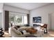 Cozy living room with large windows, hardwood floors and a modern fireplace at 2021 Grayside Cir, Castle Rock, CO 80109